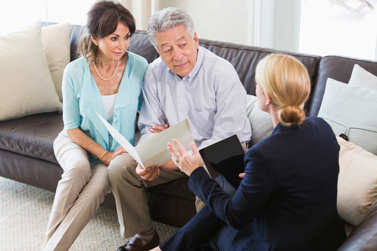 Couple talking with their financial adviser